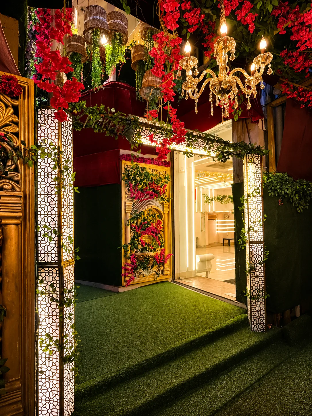 Grand entrance with bougainvillea and lattice pillars at night